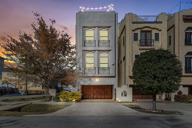 view of front facade with a balcony and a garage