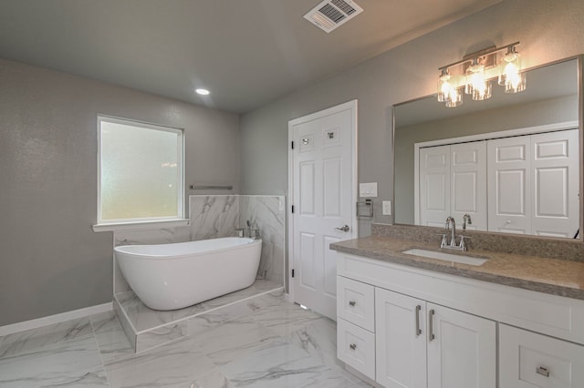 bathroom featuring a bath and vanity