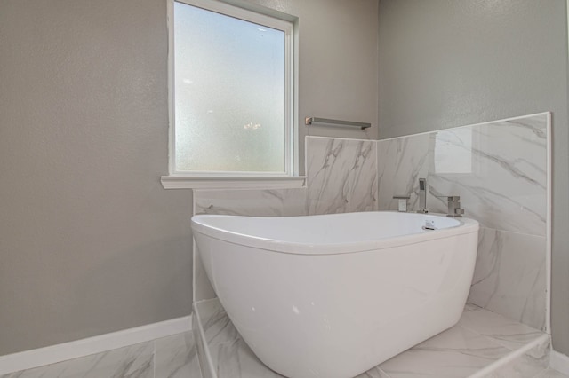 bathroom featuring a tub to relax in