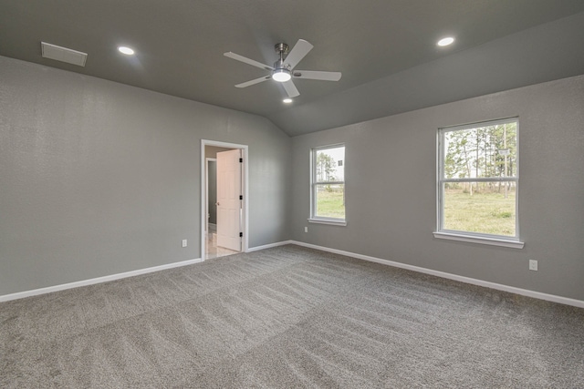 carpeted spare room with ceiling fan and lofted ceiling