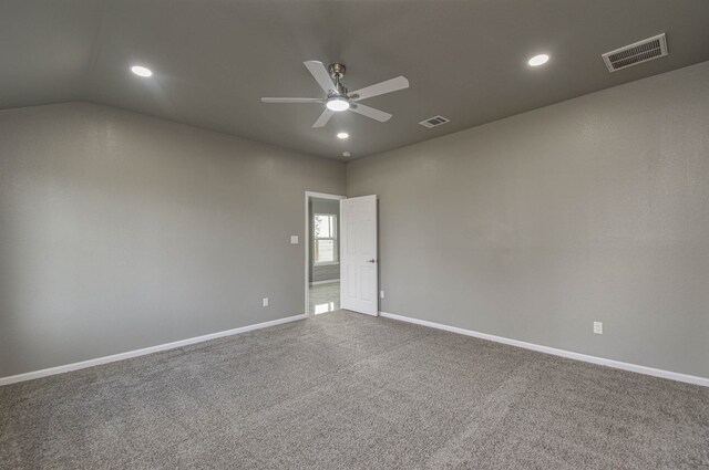 spare room with carpet floors, lofted ceiling, and ceiling fan