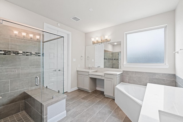 bathroom with vanity and separate shower and tub