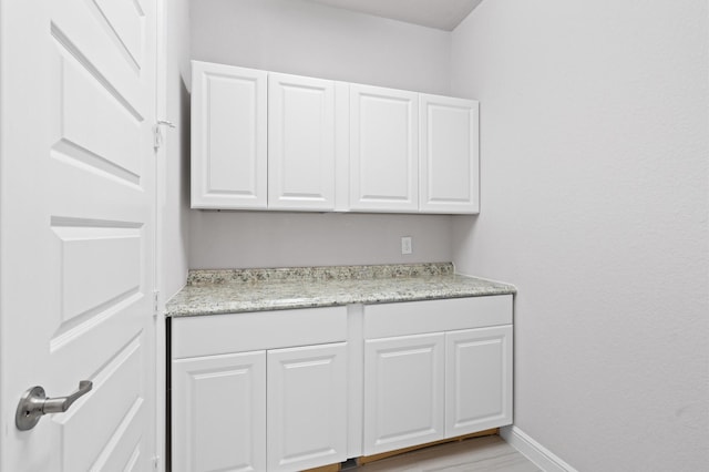 interior space featuring white cabinets and light hardwood / wood-style flooring