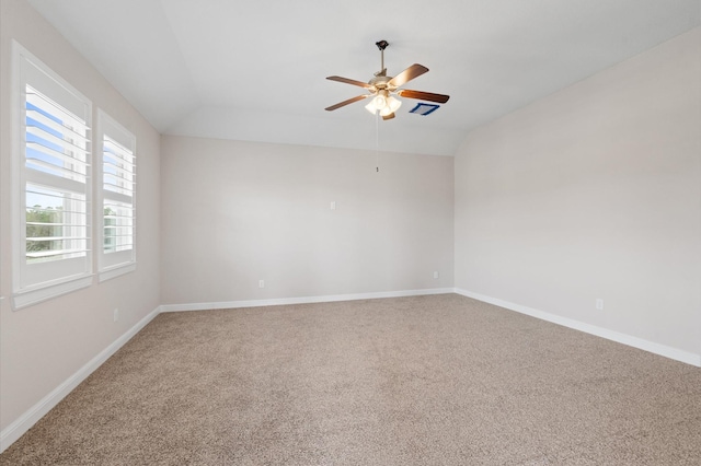 empty room featuring ceiling fan, carpet, and lofted ceiling