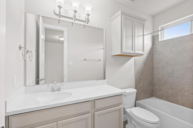 full bathroom with vanity, toilet, and tiled shower / bath combo