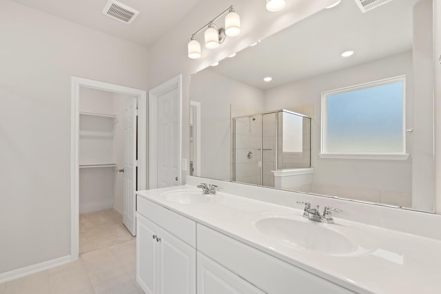 bathroom with walk in shower, tile patterned floors, and vanity