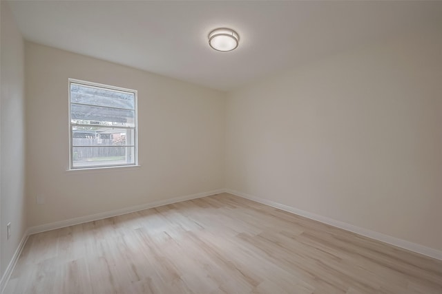 empty room with light hardwood / wood-style flooring