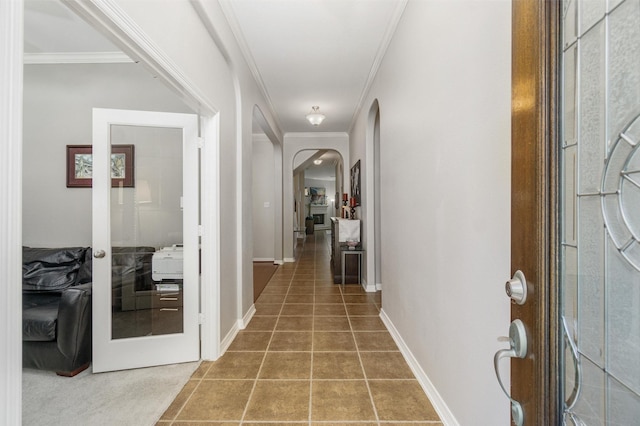 hallway with tile patterned floors, crown molding, and french doors