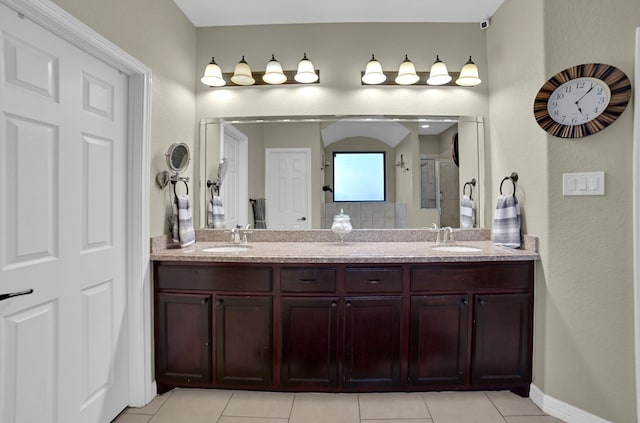 bathroom with vanity, a shower, and tile patterned floors