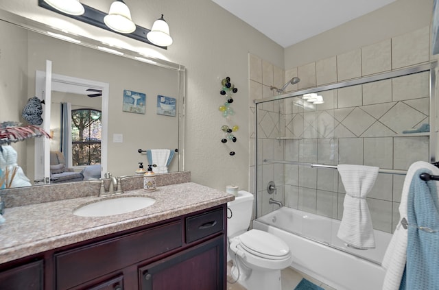 full bathroom with vanity, bath / shower combo with glass door, and toilet