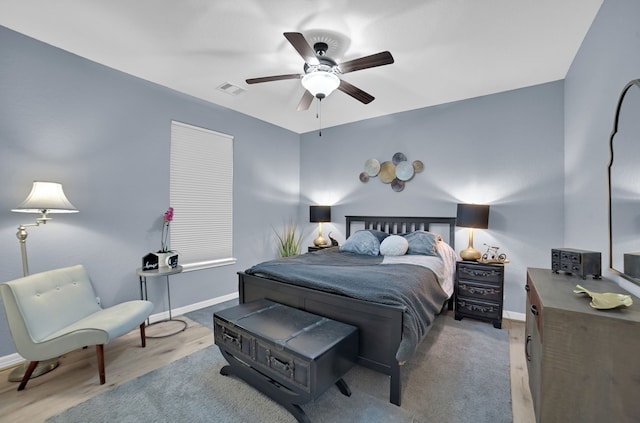 bedroom with light hardwood / wood-style flooring and ceiling fan