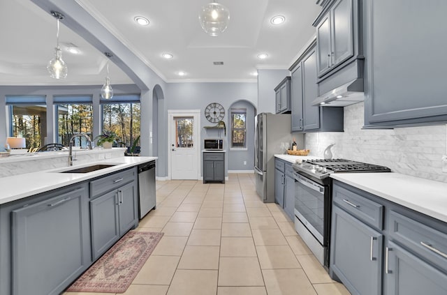 kitchen with gray cabinets, appliances with stainless steel finishes, sink, and hanging light fixtures