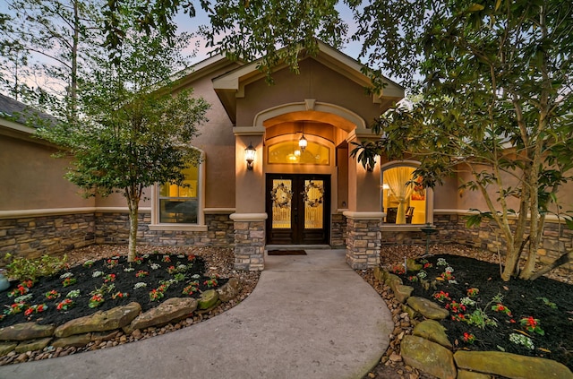 exterior entry at dusk featuring french doors