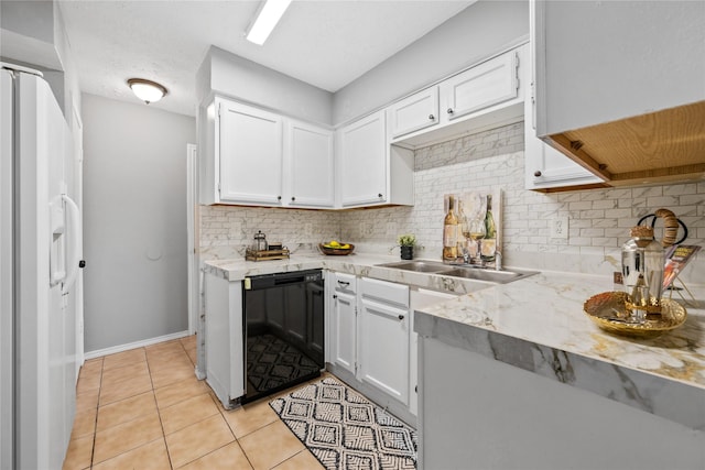 kitchen featuring white refrigerator with ice dispenser, dishwasher, sink, white cabinets, and light tile patterned floors