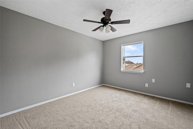 carpeted empty room with ceiling fan and a textured ceiling