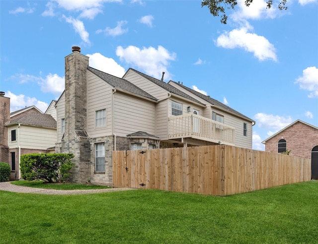 rear view of property with a lawn