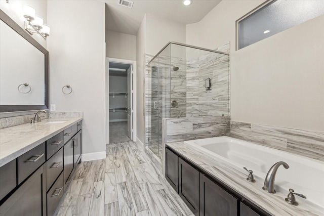 bathroom featuring independent shower and bath and vanity