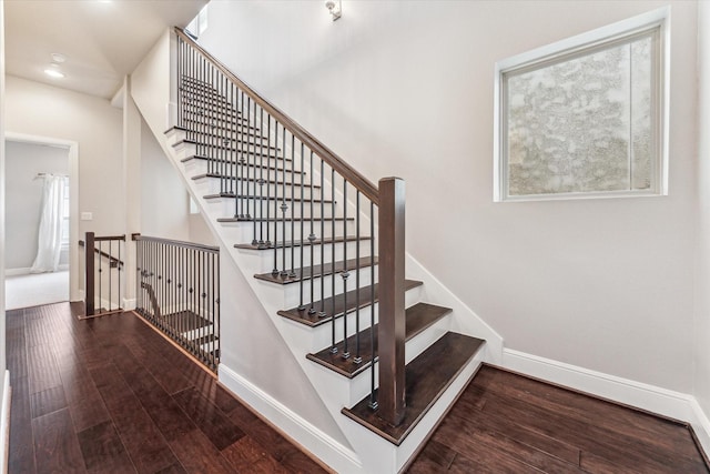 stairway featuring wood-type flooring