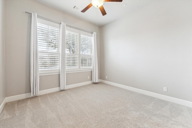 empty room with light colored carpet and ceiling fan