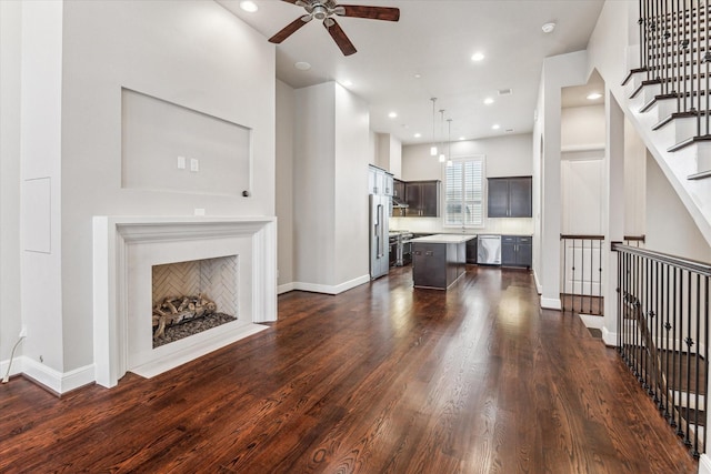 living room featuring dark wood-type flooring and ceiling fan