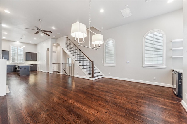 unfurnished living room featuring dark wood-type flooring, wine cooler, and ceiling fan