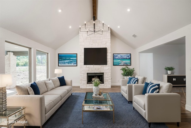 living room featuring dark hardwood / wood-style floors, lofted ceiling with beams, a chandelier, and a fireplace