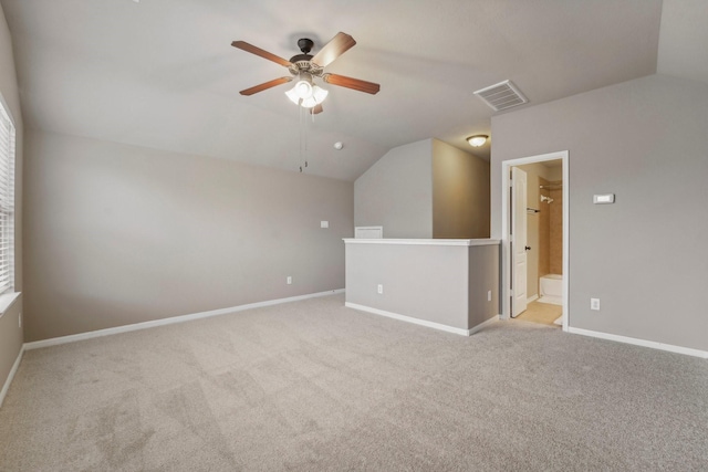 empty room featuring ceiling fan, light carpet, and lofted ceiling