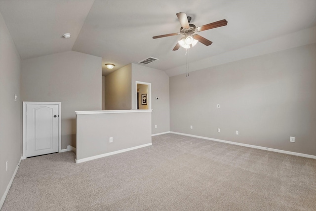 carpeted empty room with vaulted ceiling and ceiling fan