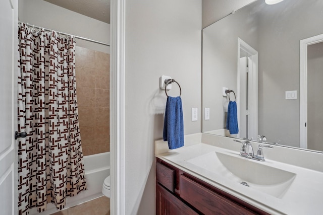 full bathroom featuring toilet, shower / bath combo with shower curtain, a textured ceiling, tile patterned flooring, and vanity