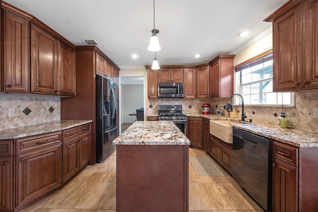 kitchen with appliances with stainless steel finishes, decorative light fixtures, sink, a center island, and crown molding