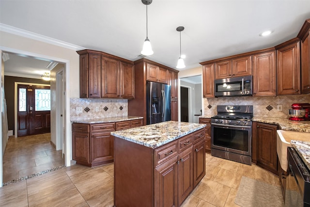 kitchen with a center island, hanging light fixtures, ornamental molding, appliances with stainless steel finishes, and decorative backsplash