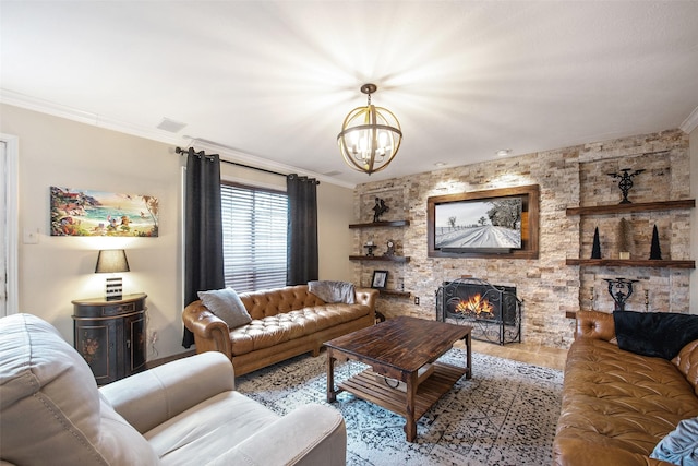 living room with a notable chandelier, crown molding, and a fireplace