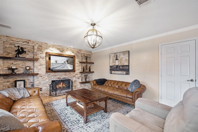 living room with an inviting chandelier, ornamental molding, and a fireplace