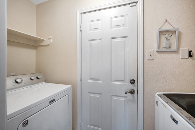 clothes washing area with washing machine and clothes dryer