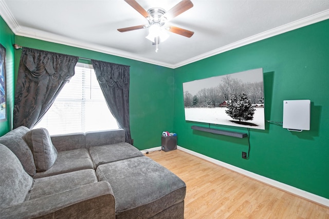 living room with hardwood / wood-style flooring, ornamental molding, and ceiling fan