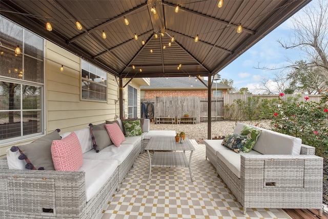 view of patio with an outdoor living space and a gazebo