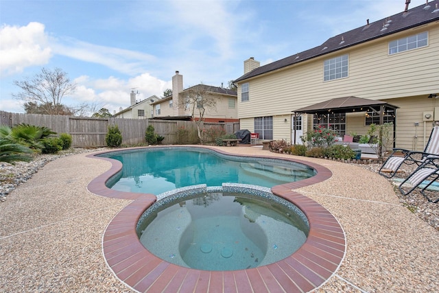 view of pool with a gazebo, a patio area, and an in ground hot tub