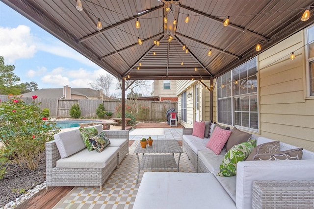 view of patio with a gazebo, outdoor lounge area, and a fenced in pool