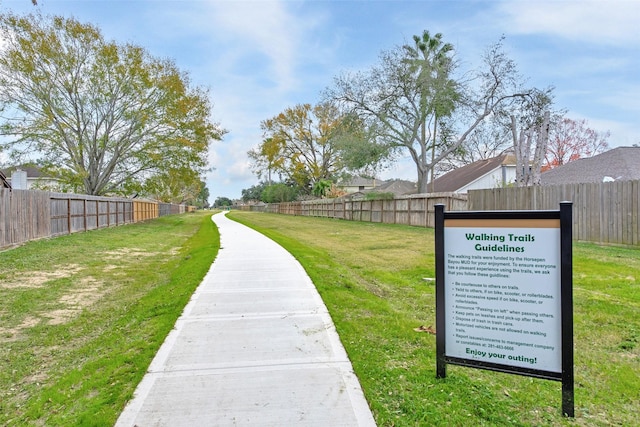 view of property's community with a lawn