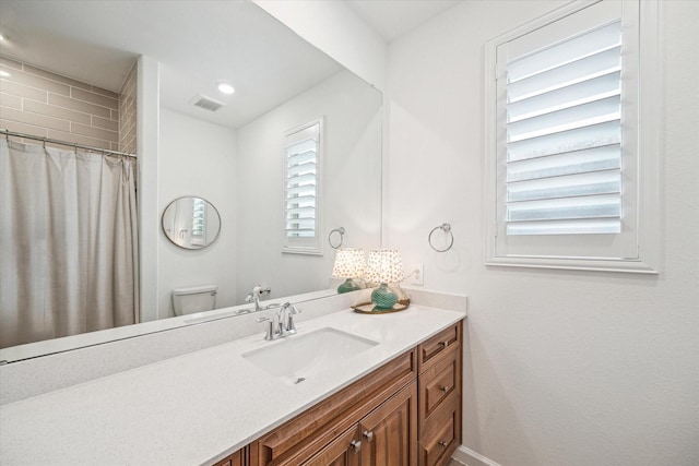 bathroom featuring toilet and vanity