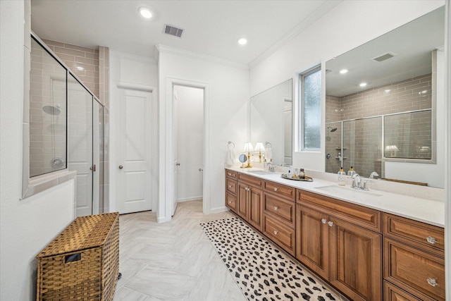 bathroom with vanity, ornamental molding, and a shower with door