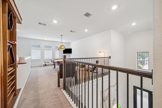 hallway featuring light colored carpet