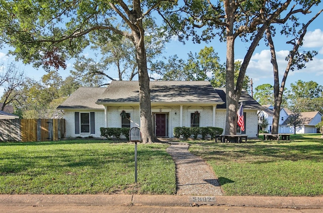 single story home featuring a front yard