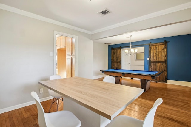 recreation room with pool table, ornamental molding, hardwood / wood-style flooring, and a barn door