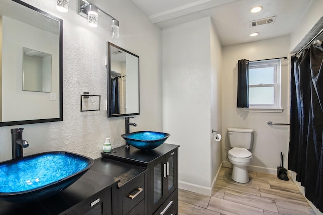 bathroom featuring toilet and vanity