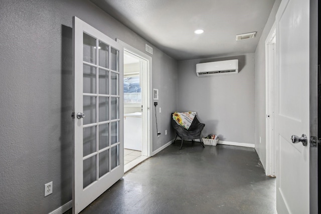 entryway featuring a wall mounted AC and french doors