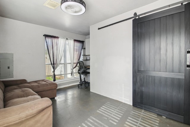 living room featuring a barn door and electric panel