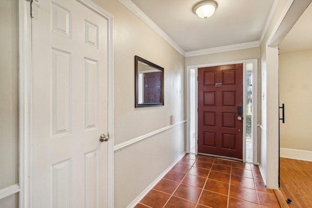 tiled foyer entrance with crown molding