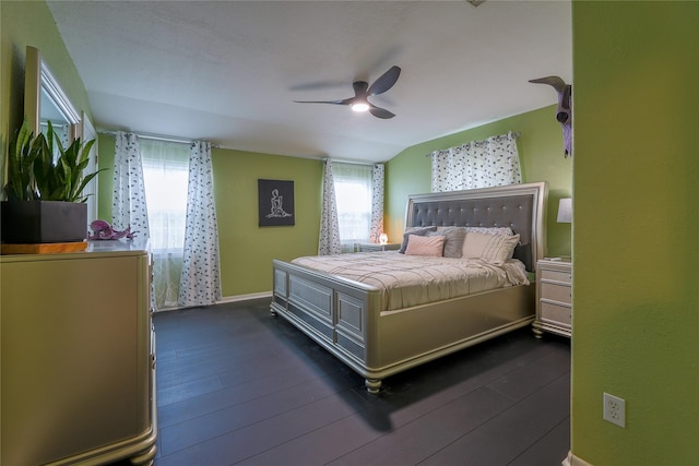 bedroom featuring dark hardwood / wood-style flooring, lofted ceiling, and ceiling fan