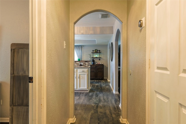 hallway with dark hardwood / wood-style flooring